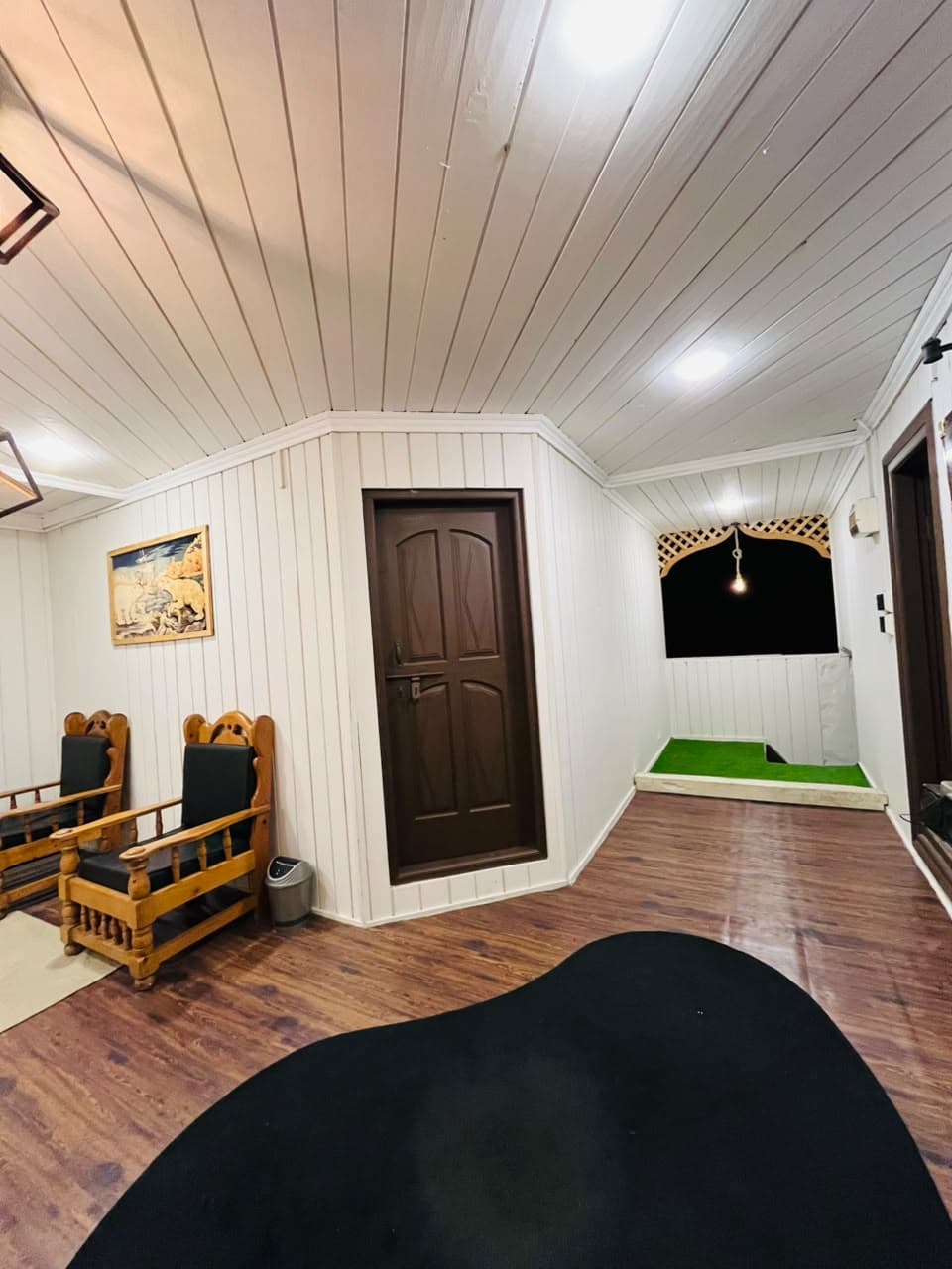 Hallway seating beside a door leading to a small terrace