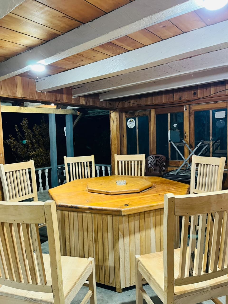 Octagonal wooden dining table surrounded by chairs