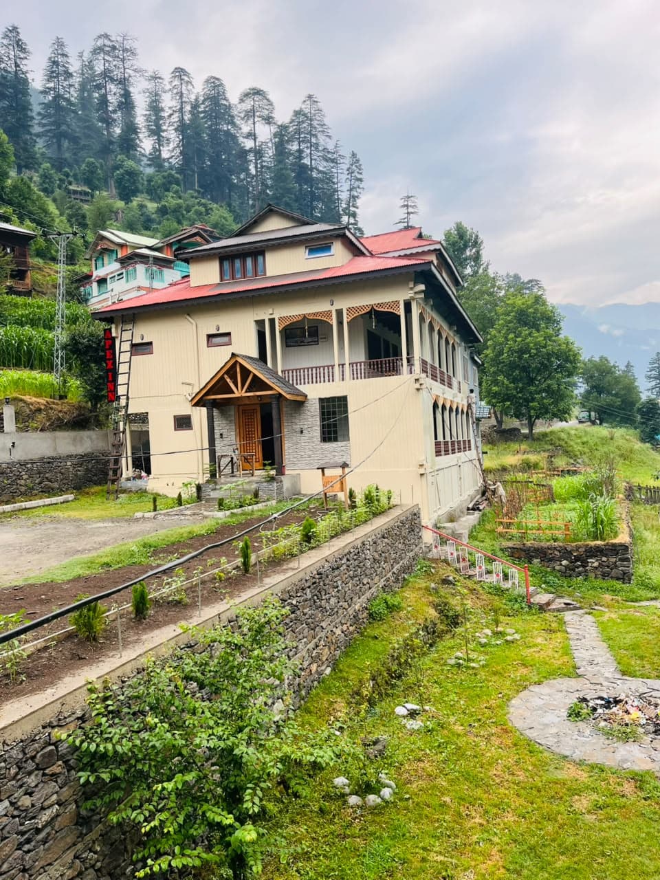 Apex Inn guest house surrounded by pine forest and gardens