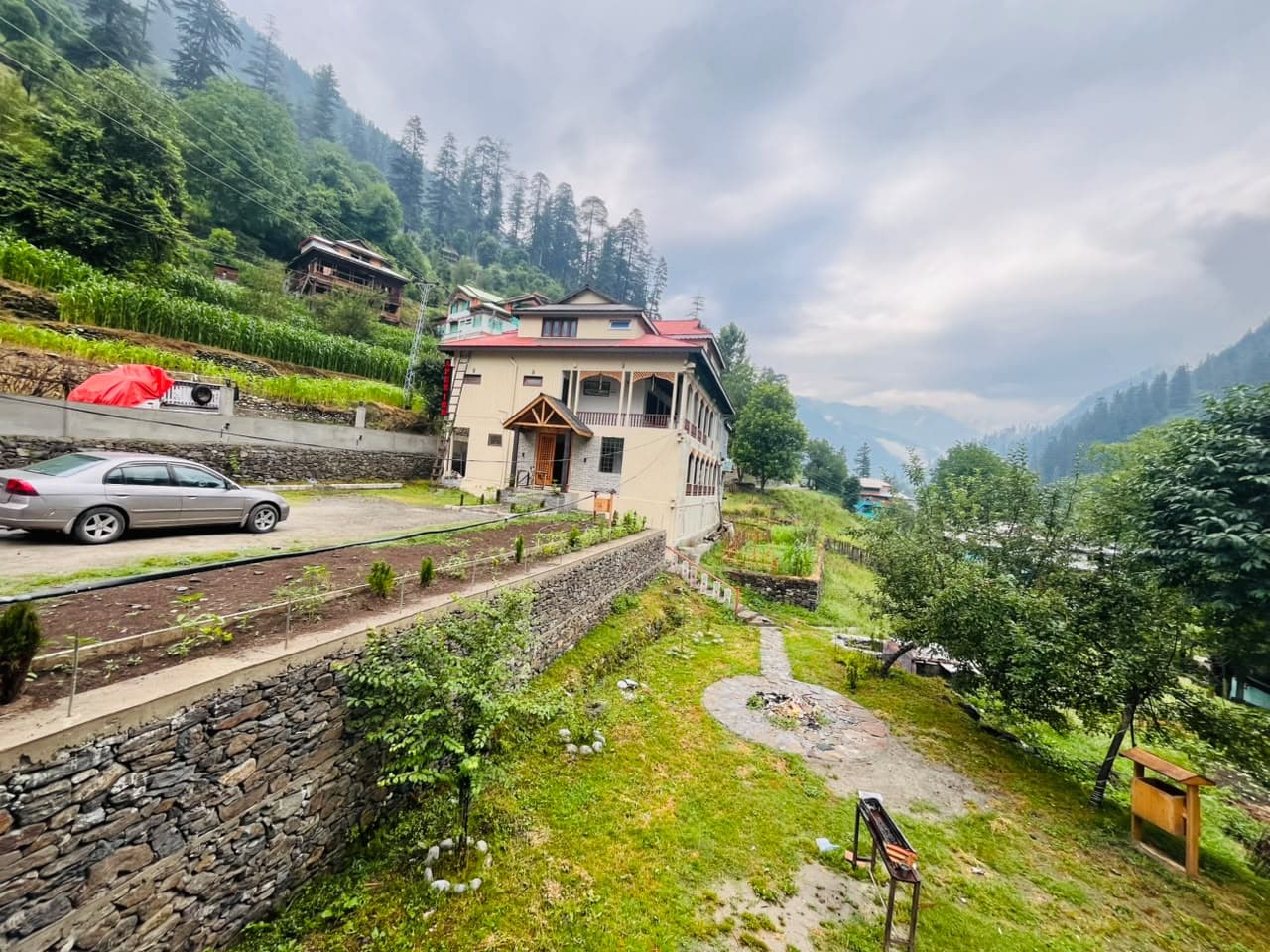 Apex Inn and its stone-walled garden under a cloudy sky