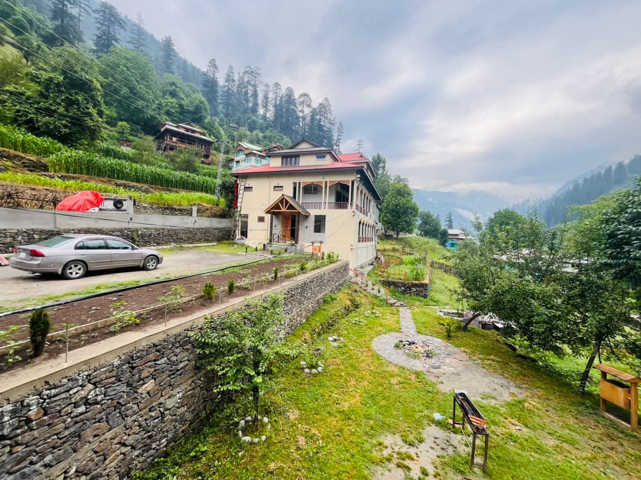 Apex Inn beside its garden with terraced fields on the hillside