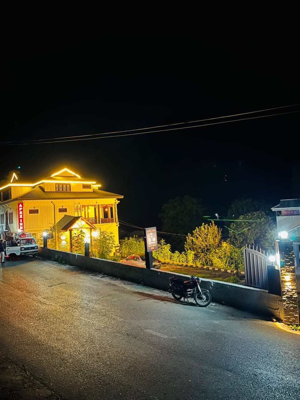 Apex Inn glowing with warm lights beside the valley road