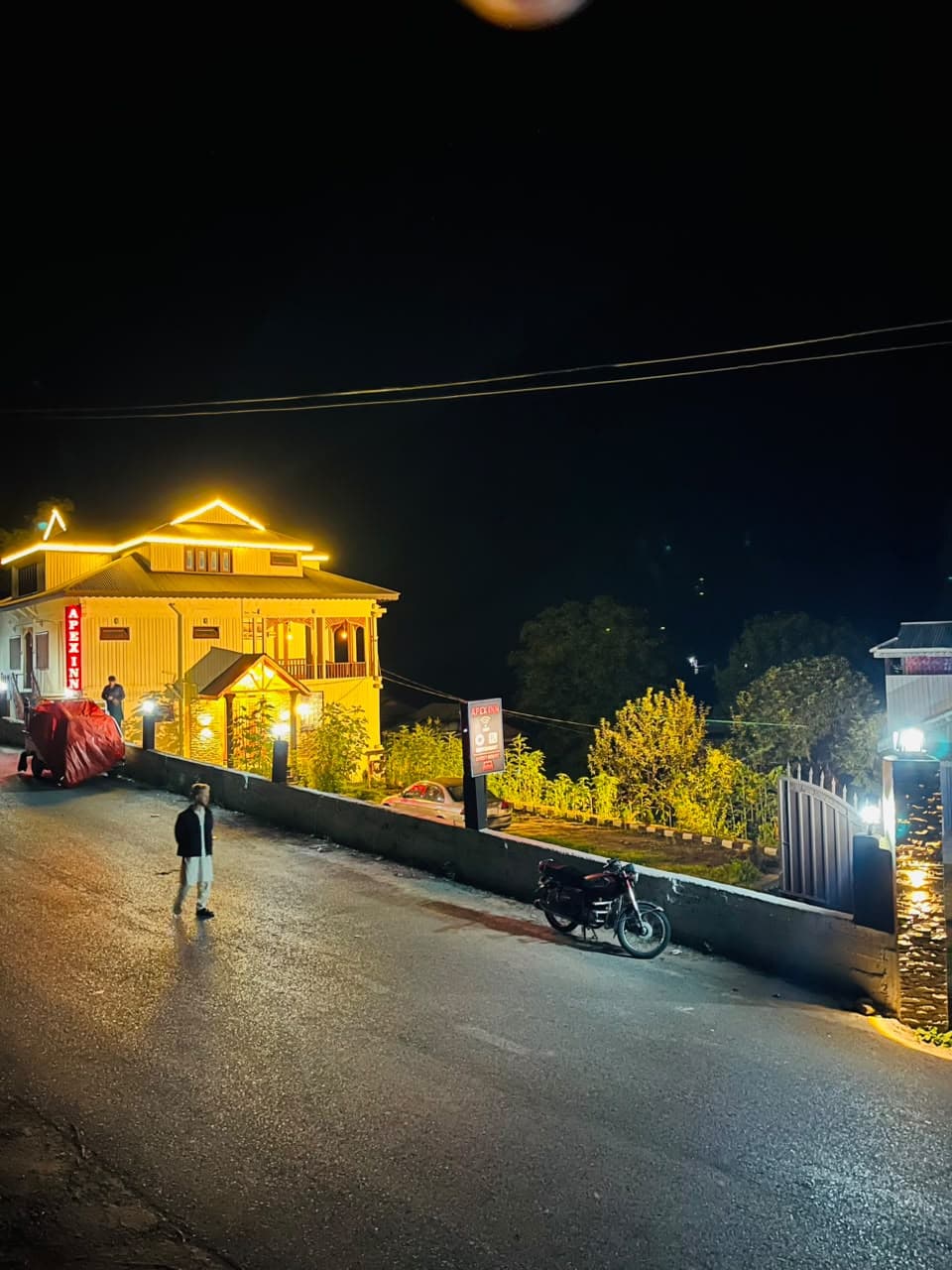 Apex Inn lit up at night seen from the road