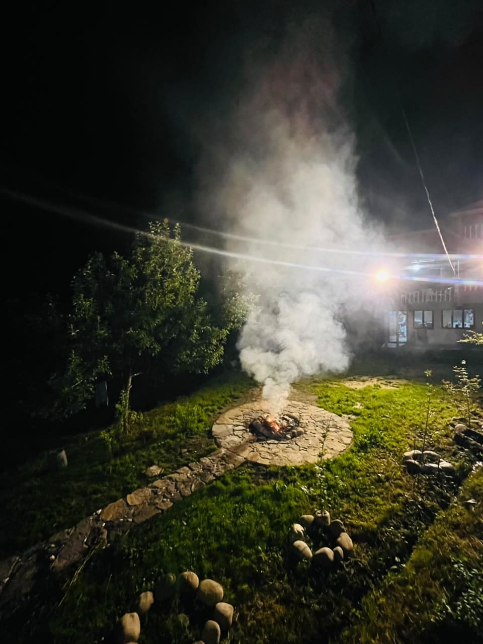 Evening fire in the stone fire pit on the Apex Inn lawn