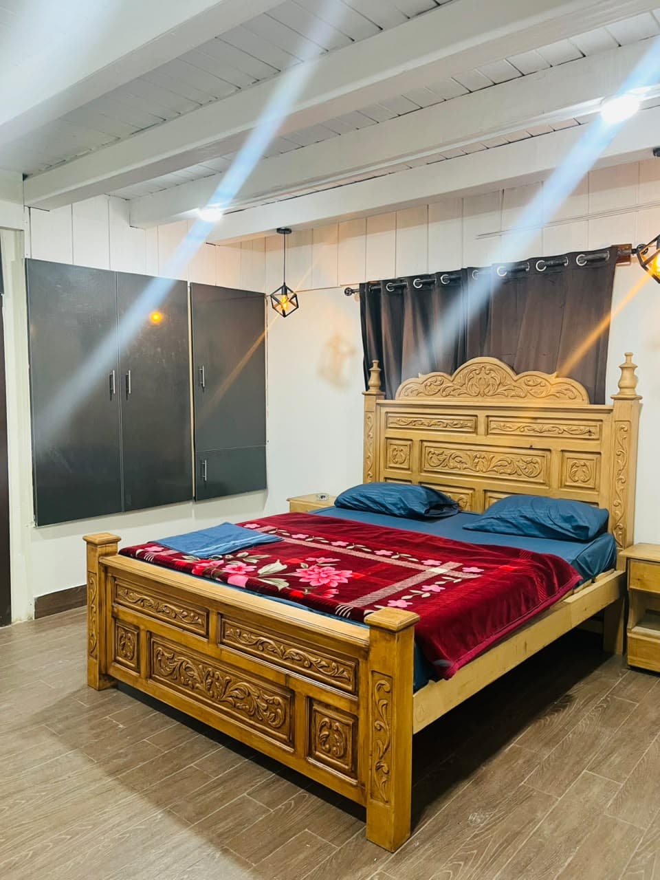 Carved king bed beside a built-in wardrobe