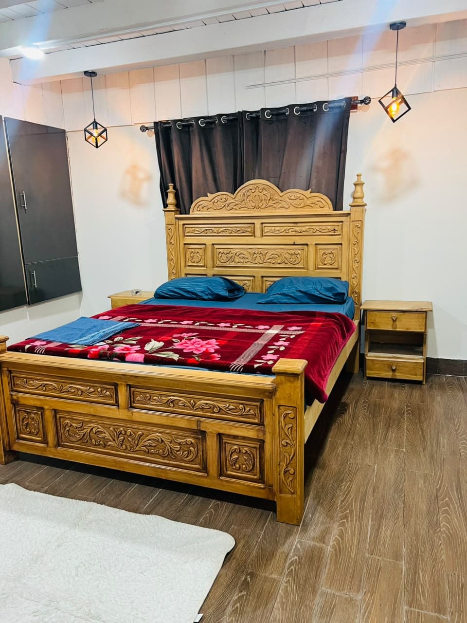 Carved king bed with bedside tables and a rug