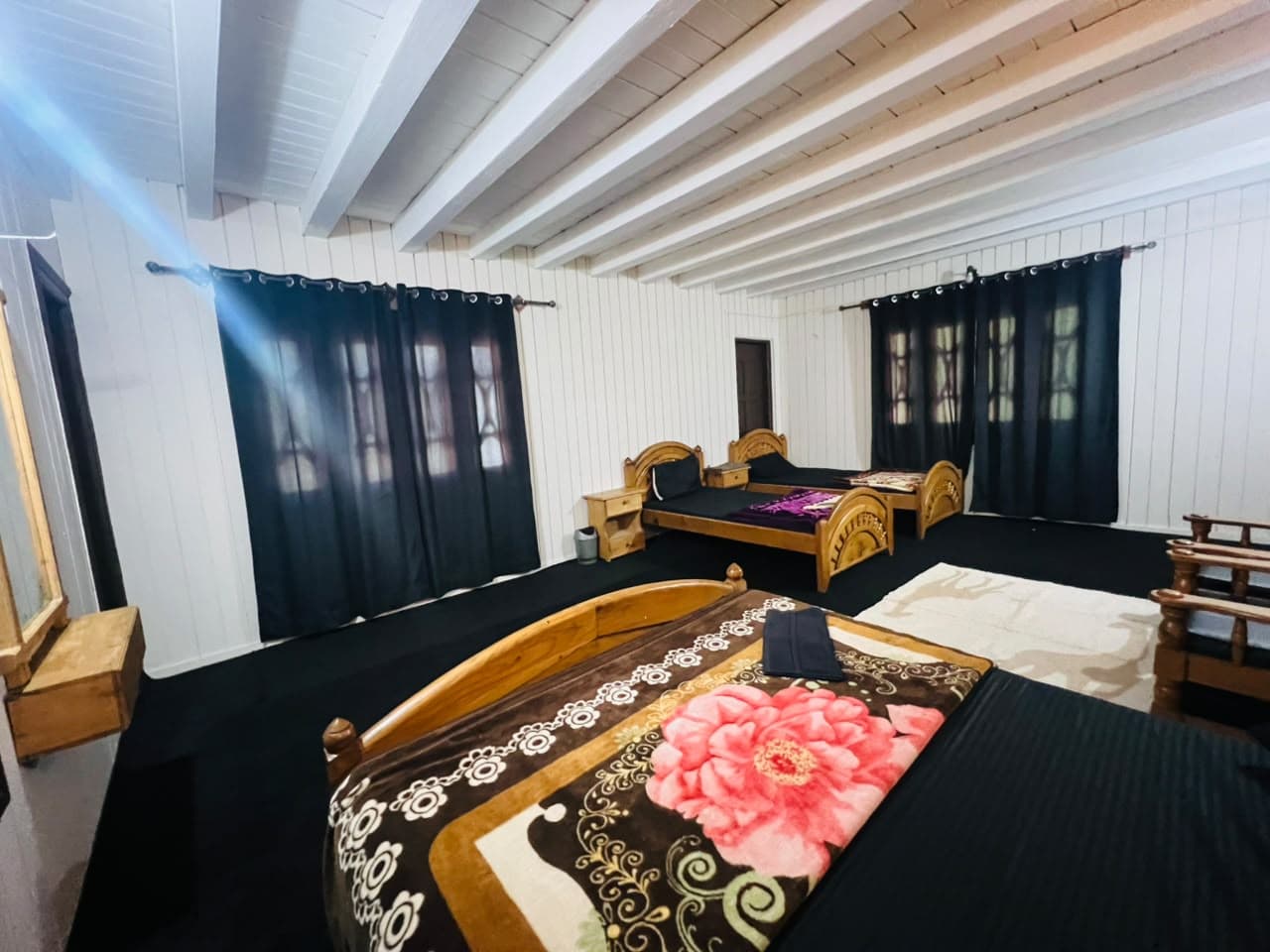 Spacious Family Room with several beds and dark curtains