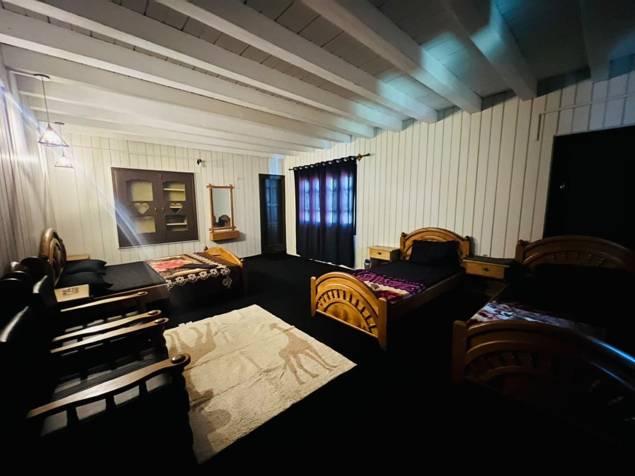 Family room with a sofa set, rug and several beds