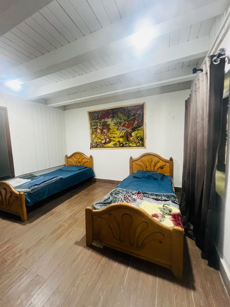 Bright twin room with two single beds and a wooden floor