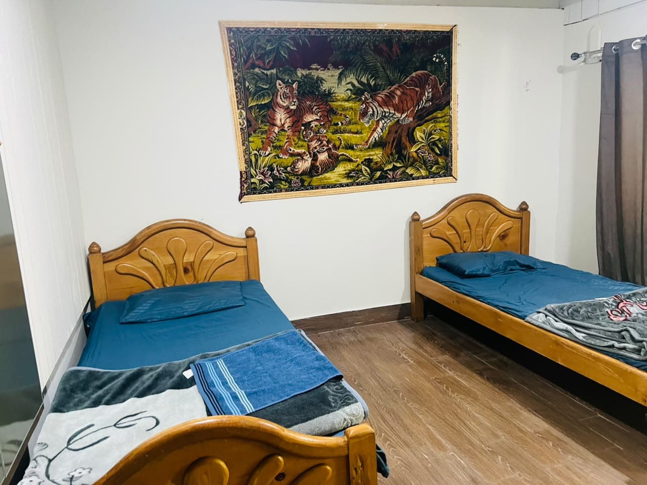 Twin room with single beds and a wooden floor